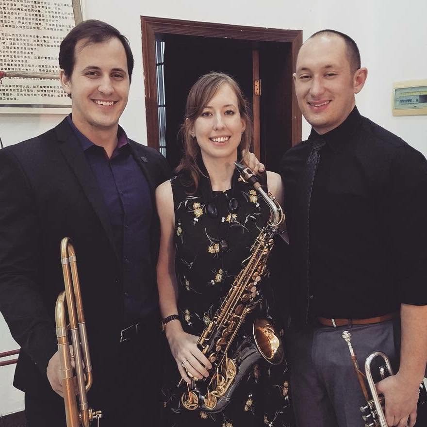Matt Waters with two bandmates holding their instruments before a performance