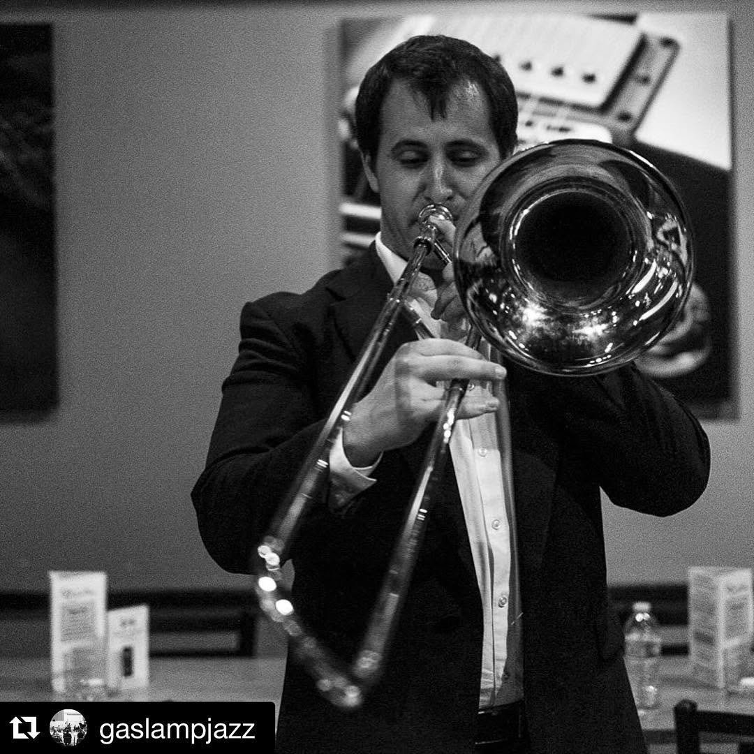 Matt Waters playing bass trombone, black and white photo