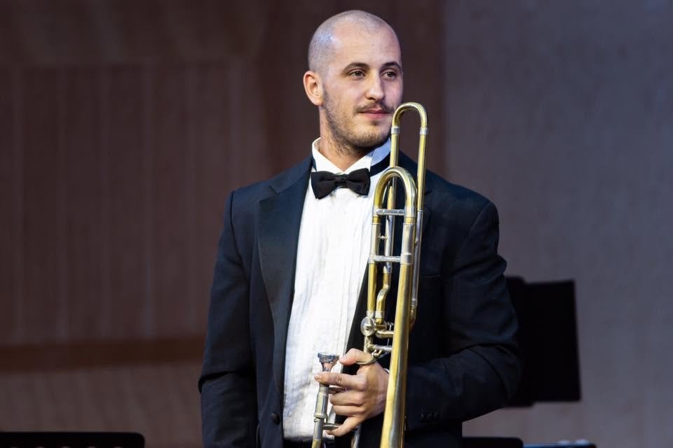 Matt Waters performing on trombone in white tie