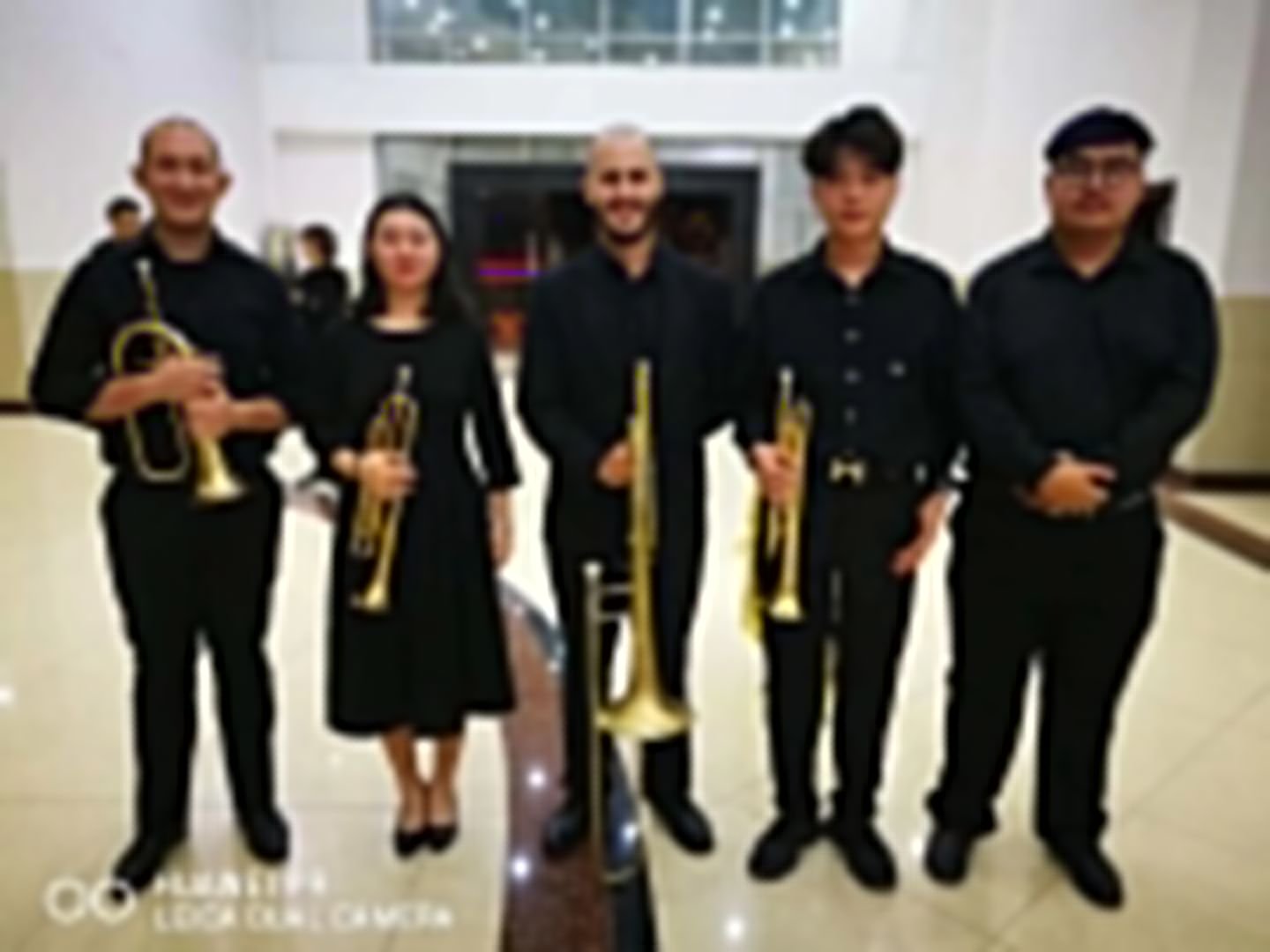 Matt Waters with four of his brass students after a concert, holding their instruments